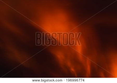 Burning red fire flame with smoke at the night abstract background.