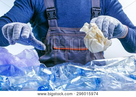 Worker Sorting Plastic Garbage For Recycling. Process Plastic Polymers Sorting. Ecology Concept.