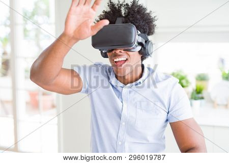 African amaerican man having fun playing with virtual reality glasses