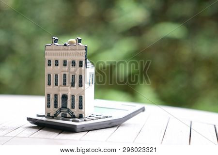 Property House With Calculator, Concept For Real Estate Or Mortgage And House Finance Or Loan