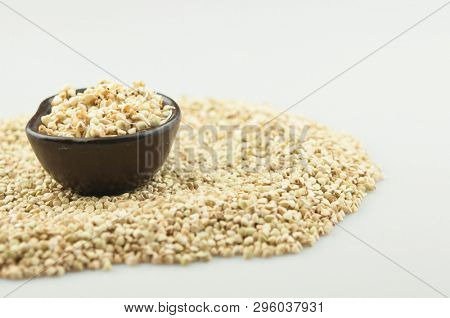 Sprouts of green buckwheat on white background. Macro shot raw organic buckwheat plant. Vegan germinated sprouts, vegetarian cuisine. Healthy diet buckwheat porridge food. 