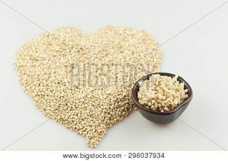 Sprouts of green buckwheat on white background. Macro shot raw organic buckwheat plant. Vegan germinated sprouts, vegetarian cuisine. Healthy diet buckwheat porridge food. 