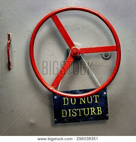 Do Not Disturb Warning Sign Plate Hanging On A Hermetic Bomb Shelter Armored Door