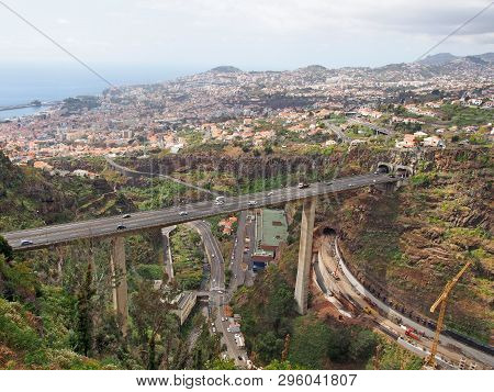 An Aerial View Of The City Of Funchal In Madeira With A Bridge Carrying The Vr1 Motorway Crossing Th