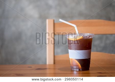 Iced Coffee Dink With Orange Slices In Glass On Wood Table