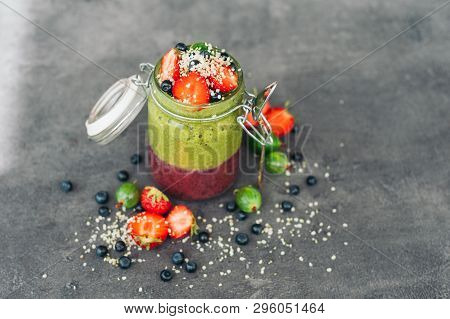 Jar Of Fruit Smoothie With Exotic Fruits Strawberry, Gooseberry And Blueberry With Coconut Flakes Is
