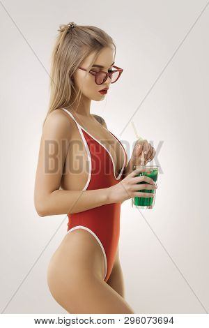 Glamour Beach Woman With Perfect Makeup Wearing Sexy Red Bikini And Retro Sunglasses Holding Cocktai