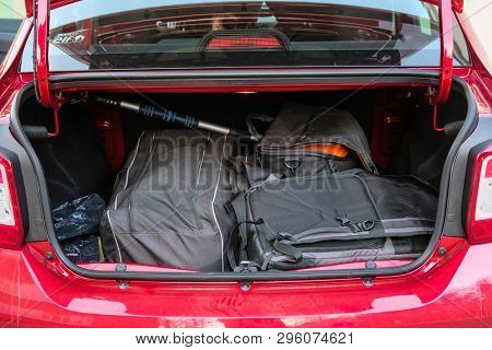 Moscow, Russia - April, 15, 2019: bag, suitcase and other luggage in the open trunk of the red car Renault Logan Stepway