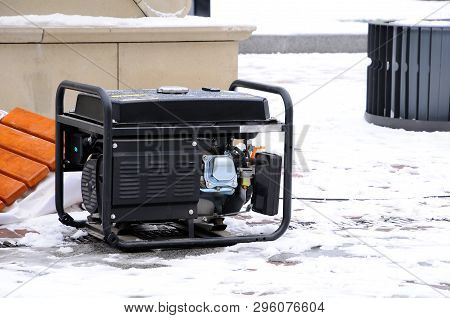 Portable Electric Generator Running In The Cold Winter.