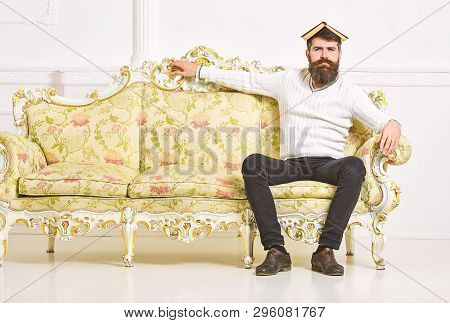 Macho Sits With Open Book On Head, Like Roof. Overstudy Concept. Guy Overdid With Studying, Fed Up O