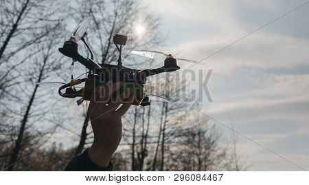 Pilot Racing Drone Holds In His Hand Fpv Copter Before Launching It. A Small High-speed Aircraft Wit