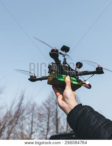 Pilot Racing Drone Holds In His Hand Fpv Copter Before Launching It. A Small High-speed Aircraft Wit