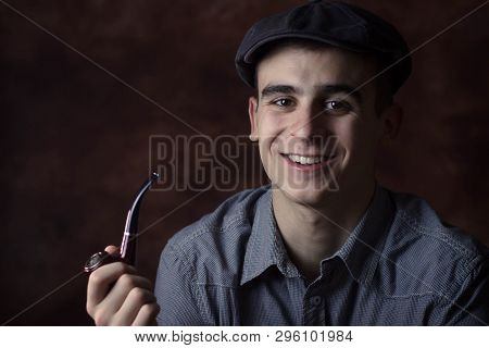 Young Man Smoking A Pipe. Happy, Smiling. Retro Concept