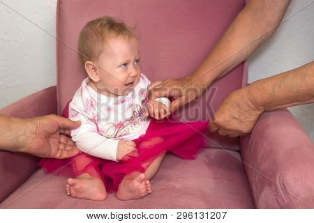 Crying Toddler. Hands Of The Adults, Parents Trying To Calm Down Crying Toddler.