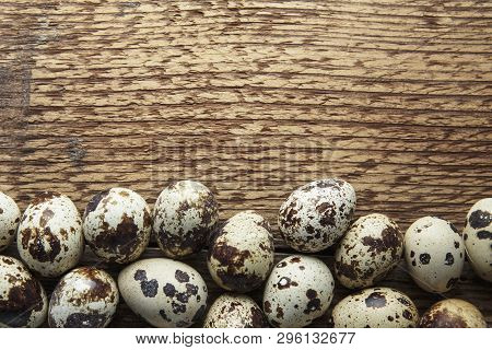 Quail Eggs. Flat Lay Composition With Small Quail Eggs On The Natural Wooden Background. One Broken