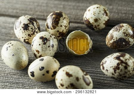 Quail Eggs. Flat Lay Composition With Small Quail Eggs On The Natural Wooden Background. One Broken