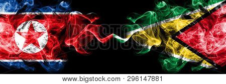 North Korea Vs Guyana, Guyanese Smoky Mystic Flags Placed Side By Side. Thick Colored Silky Smoke Fl