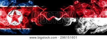 North Korea Vs Monaco, Monacan Smoky Mystic Flags Placed Side By Side. Thick Colored Silky Smoke Fla