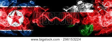 North Korea Vs Oman, Omani Smoky Mystic Flags Placed Side By Side. Thick Colored Silky Smoke Flags O