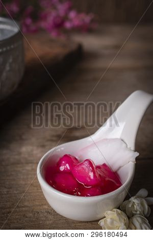 Thapthim Krop, Mock Pomegranate Seeds In Coconut And Syrup In The White Spoon Bowl On The Wood Table