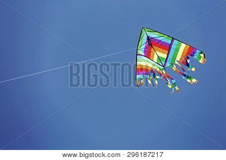 Multcolored Kite On The Blue Sky With Old Toned Effect