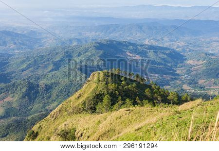 Phu Nom At Phu Langka National Park With Yellow Sun Light Normal. Phu Nom Mountain With Grass Field 