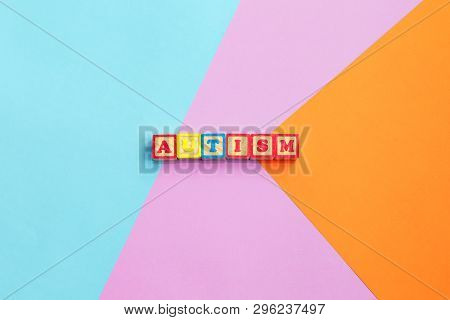 Autism Colorful Word From Color Wooden Letters On Colorful Background. Concept Image Top View. Copy 