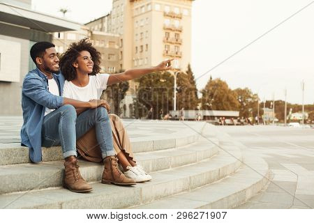 Look Here. African-american Couple Of Tourists Walking In City, Woman Pointing Somewhere, Copy Space