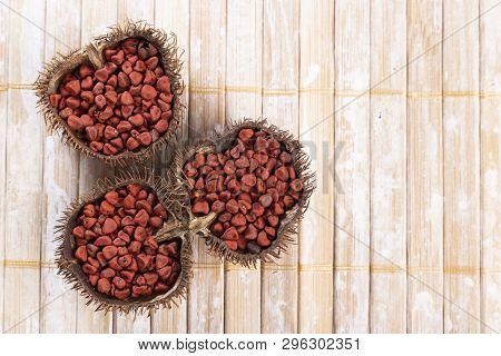 Annatto Seeds On Rustic Wood