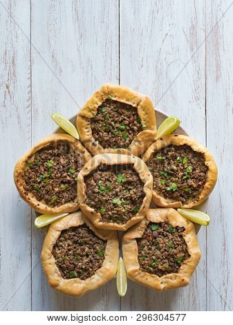 Arabic Meat Sfiha Over A Wooden Table. Top View Of Arabic Esfiha.
