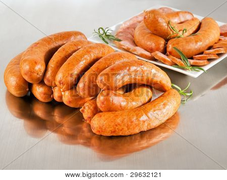 Arrangement With Fresh Pork Sausage On A Steel Silver Board.