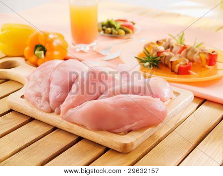 Fresh Raw Chicken Breast Arrangement On Kitchen Cutting Board