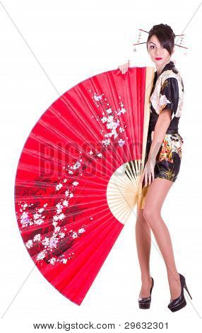 Beautiful young woman in Asian costume with red Asian fan