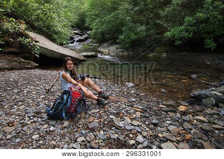 A Young Woman Sitting By A Trailside Stream In The Great Smoky Mountains National Park, Tennessee, I