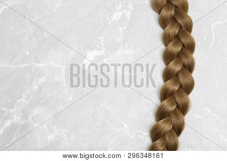 Braided Hair On Grey Background, Top View With Space For Text