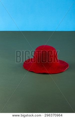 Still Life With A Red Woolen Hat On A Green Table