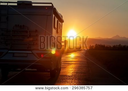 Campervan On The Road Heading To Sunset