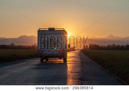 Campervan On The Road Heading To Sunset
