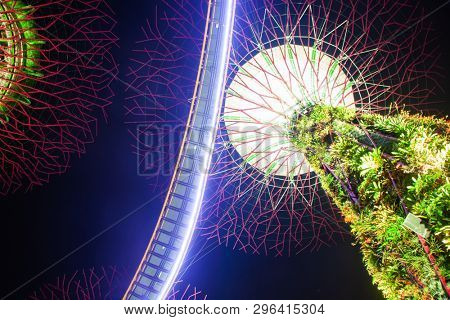 SINGAPORE, SINGAPORE - MARCH 2019: Supertree Grove & OCBC Skyway illuminated for light show in gardens by the bay