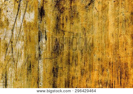 Rusty Yellow-brown Textured Metal Surface. The Texture Of The Metal Sheet Is Subject To Oxidation An