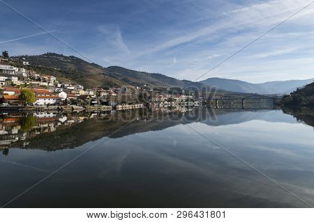 View Of The Pinhao Village With Terraced Vineyards And The Douro River, In Portugal; Concept For Tra