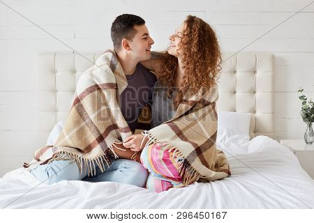 Photo Of Girlfriend And Boyfriend Dressed Casually, Enjoy Coziness Under Plaid In Bedroom, Embrace E