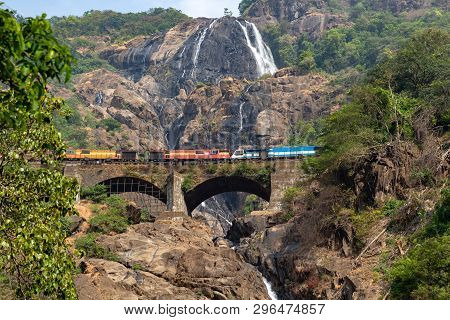 Train On The Railway Bridge On The Background Of The Dudhsagar Falls
