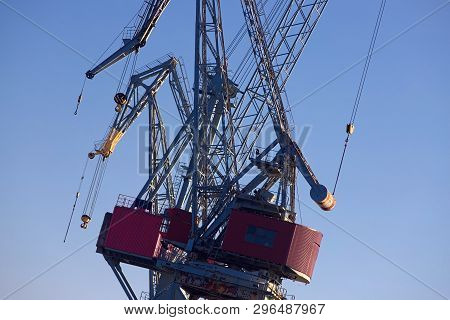 Huge Freight Cranes In Helsinki Harbor, Standing Out Before Blue Sky