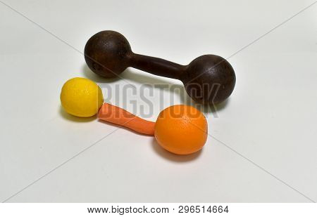 Funny Dumbbell Made Of Carrot Orange And Lemon With A Number Of Lying Real Old Dumbbell On An Isolat