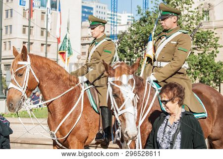 Santiago Chile - June 24 2012; Tourist Stands Close To Staunch Mounted Police On Horseback In City S