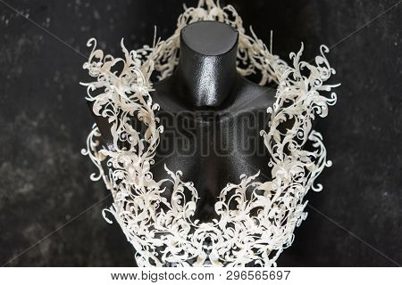 Piece made with 3d printer, is composed of white flowers that form a corset, handmade, fantasy design Baroque style