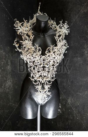 Manikin, Piece made with 3d printer, is composed of white flowers that form a corset, handmade, fantasy design Baroque style