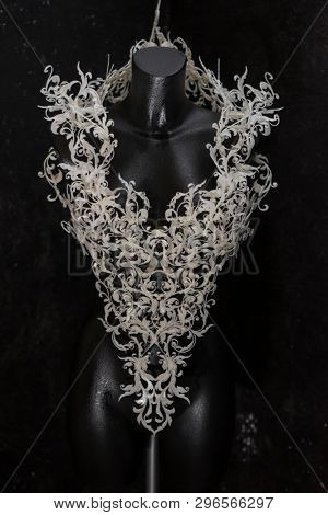 Piece made with 3d printer, is composed of white flowers that form a corset, handmade, fantasy design Baroque style