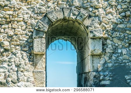 Entrance Doorway In The Stone Wall, Arch For Entrance And Exit In The Ruins Of The Old City Against 